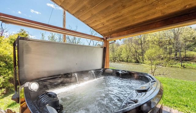 Riverside retreat with hot tub, scenic views, rustic charm & open-plan luxury – perfect escape!