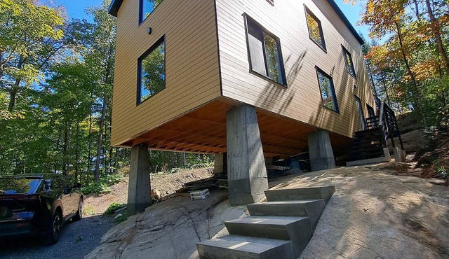 Rock House -Beautiful Architecture in the trees nestled between two lakes