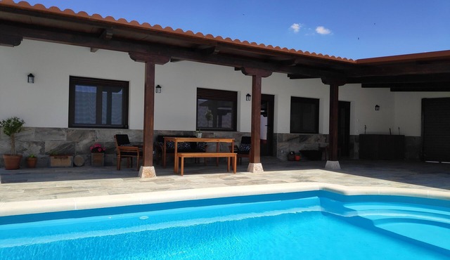 Rural house with pool and garden.