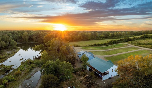 Rustic cabin on a quiet stretch of the Glover River. Three queen suites and a bunk loft sleep up to 13. Kayak from the backyard, soak in the hot tub, gather at the fire pit. Inside: game loft with ping pong, and Nintendo. FREE Gym at Sweat Shack.