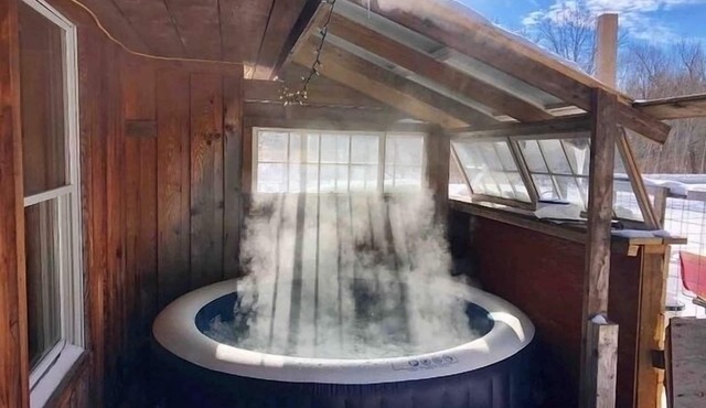 Rustic cabin w/29 acres. Enjoy a hot tub, wood stove, nature trails and more.