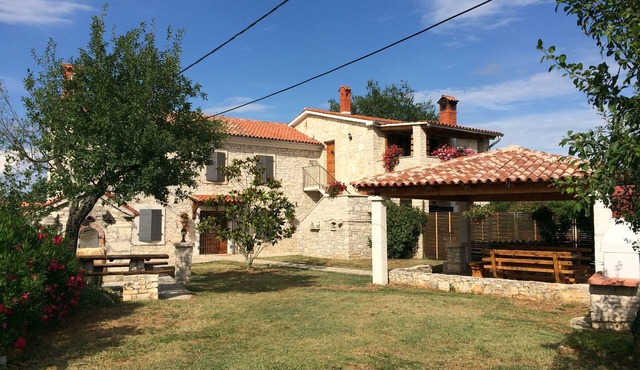Rustic farmhouse surrounded by the greenery of the large and spacious garden . with swimming pool