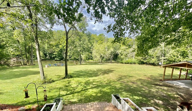 Rustic large luxury home with 300 feet of riverfront surrounded by woods.