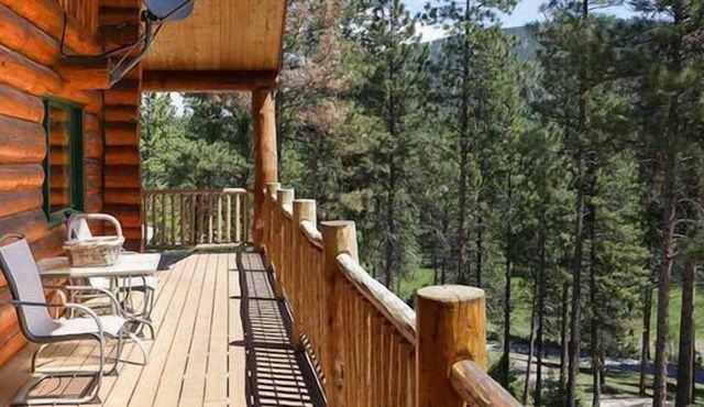 Rustic, spacious, log home nestled into the hillside of 2 acres near river access.