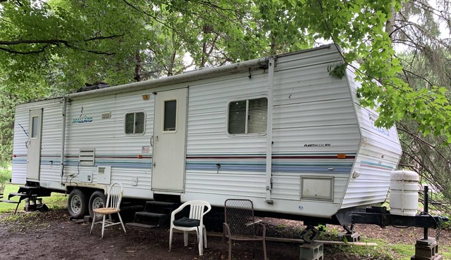 RV slide out wooded country setting