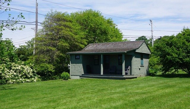 Sakonnet Point water view cottage with 8 minute walk to idyllic private beach .