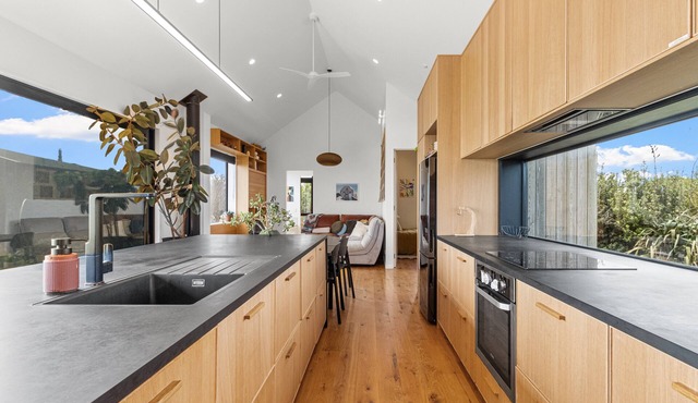 Sauna, seafront, and architecture steps away from the Tasman Sea