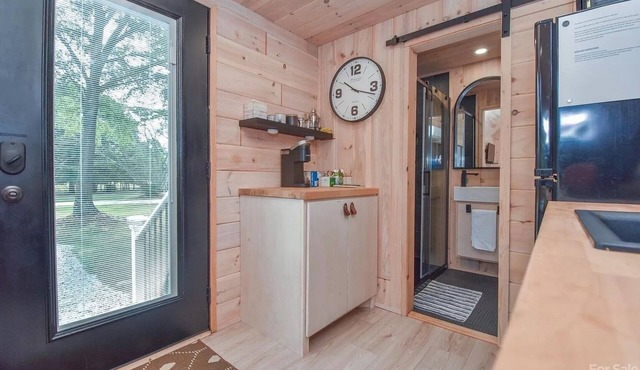 Scandinavian tiny home surrounded by nature with patio, solo fire pit, grill.