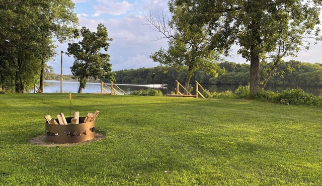 Scenic riverfront cottage with boat landing and docks.