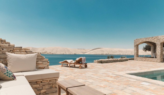 Seafront stone house with a pool