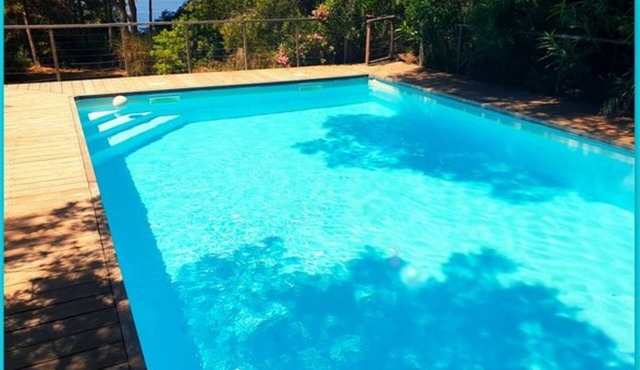 Seafront with direct beach access and private heated pool in a green setting