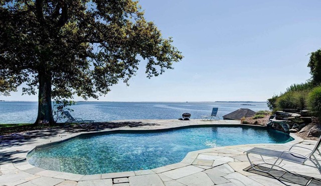Seas the Day at this water front home with sweeping views of the Bay