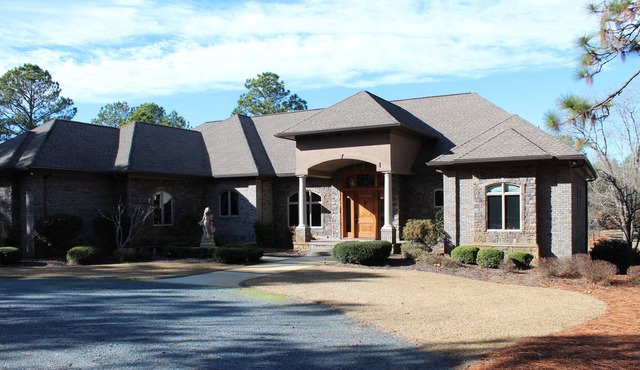 Secluded 22 ac with 6,500 sq ft home 4 BR/ 5 BA pool, deck 2 ½ ac pond, kid area