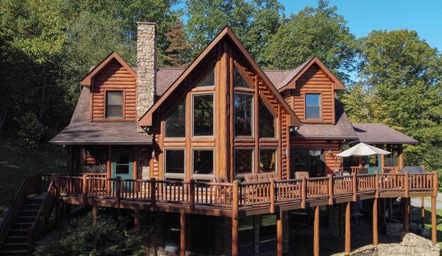 Secluded 4 bedroom log style home with screened porches, deck and fishing pond.