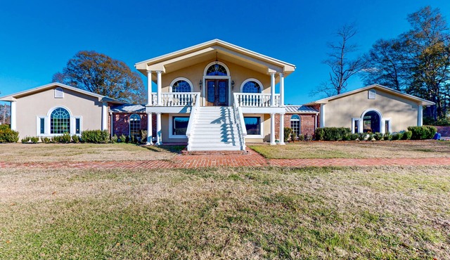 Secluded acreage with six bedrooms, pool, wood fireplace, ponds, grill, & AC