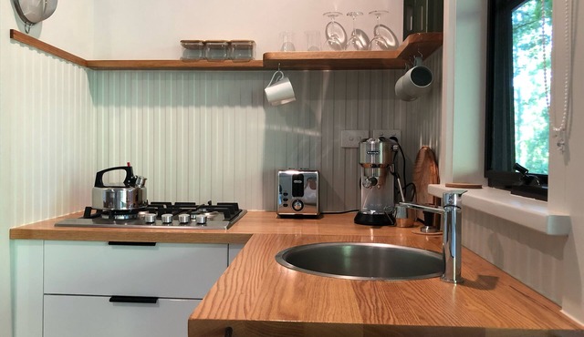 Secluded cottage with outdoor bath, river access, bikes, and farm animals.