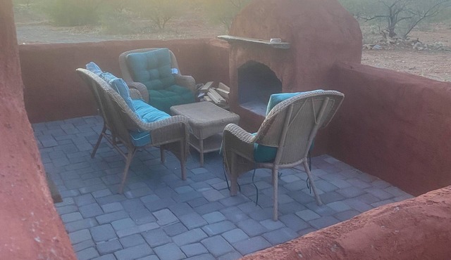 Secluded desert guest house with outdoor fireplace.