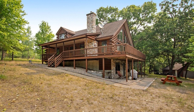 Secluded, dog-friendly home with tree-lined view, firepit, fireplace, & deck
