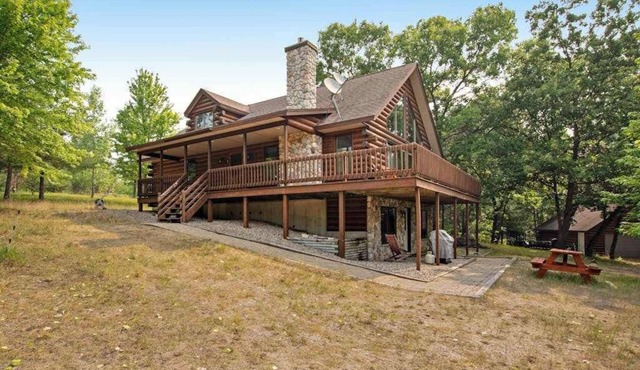 Secluded, dog-friendly home with tree-lined view, firepit, fireplace, & deck