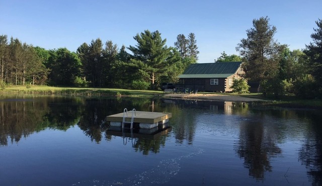 Secluded family-friendly log cabin with swimming pond. Charm, comfort.