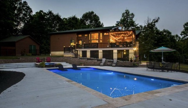 Secluded log cabin home located on 13 acres with salt water pool & jacuzzi.
