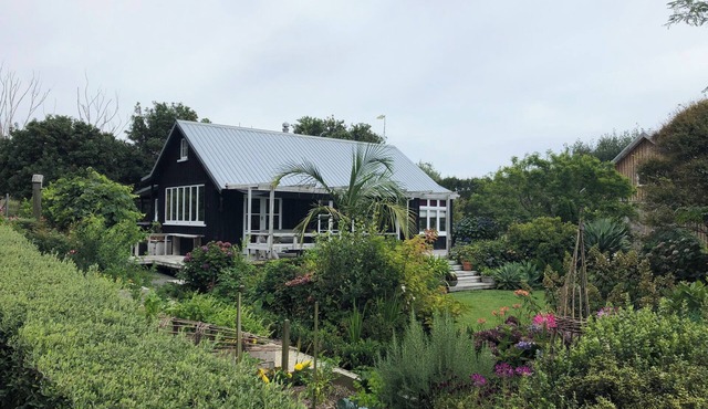 Secluded peaceful romantic cottage , set in beautiful gardens next to beach.