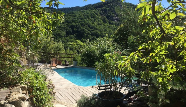 Secluded stone house on the banks of a stream with swimming pool