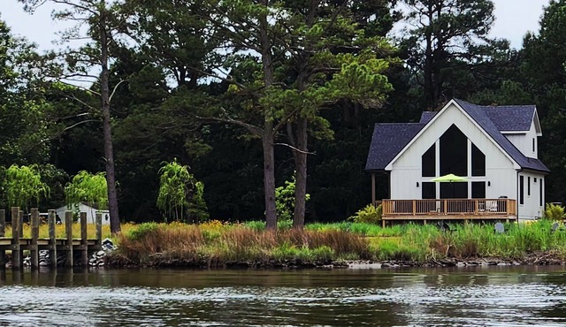 Secluded waterfront getaway with hot tub,fire pit, and private dock.