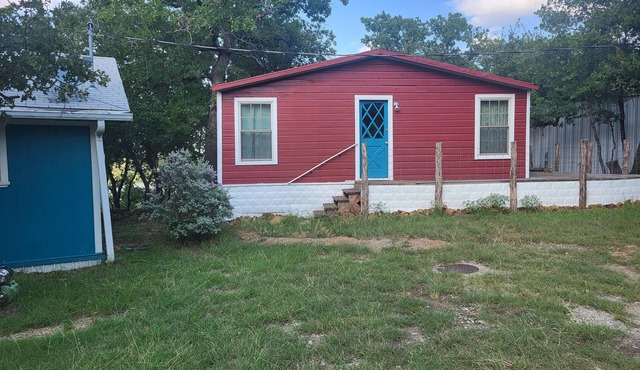 Serene lake front cabin set on bluff overlooking Palo Pinto lake.