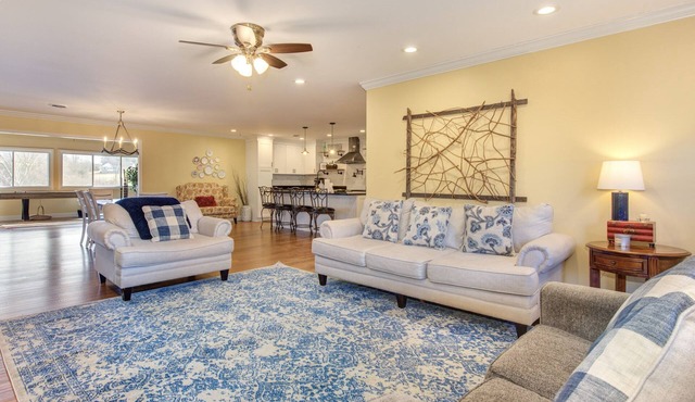 Serene lake views featuring a private dock, sun deck + spacious fire pit