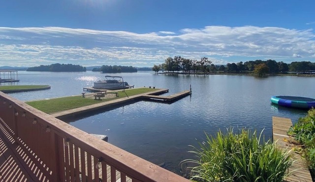 Serene lakefront condo with stunning views, private boat slip, and spacious deck