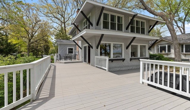 Serene lakefront house with expansive deck and pier