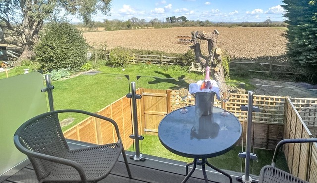 Set in a tranquil location with a balcony overlooking the fields and countryside.