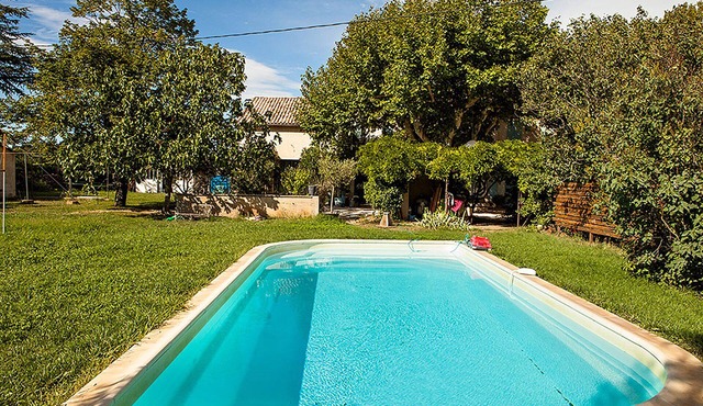 Shaded farmhouse in the middle of meadows with swimming pool and large garden