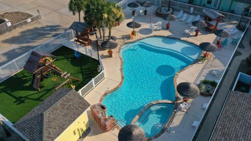 Shared Resort-Style Pool Playground Patio w Bar Tidal Times by AvantStay