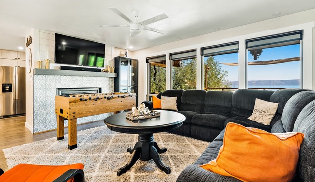 Single-level, lakefront getaway with mini-bar, furnished deck & mountain views