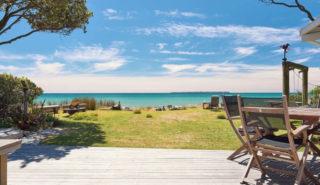 Sit back relax and watch the waves lap from your beachfront holiday home.