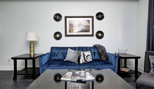 Sleeps 6 comfortably: 3 stylish bedrooms with plush bedding and blackout curtains. Music-themed decor: curated vinyls, vintage instruments, and artwork. This short-term rental features bold décor, modern amenities, and walkable access to