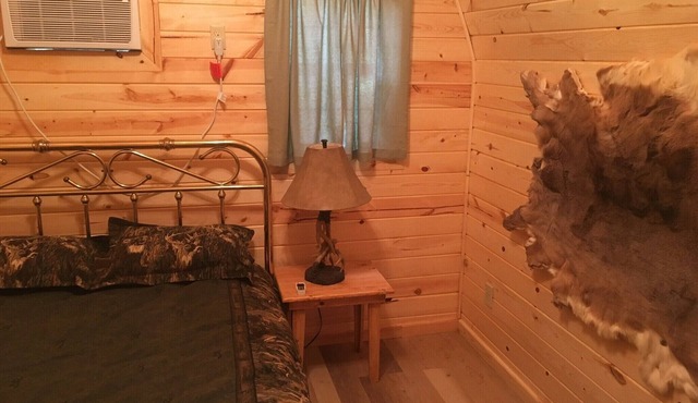 Small one room cabins with no bathrooms hot tub and covered picnic tables.