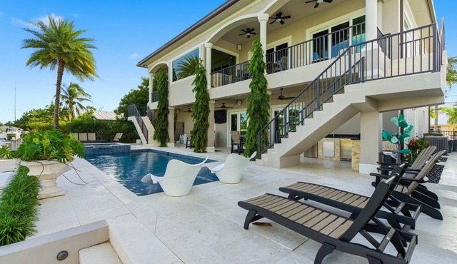 Southern Palms -Luxury 5 Bd/6 Bath waterfront home on wide canal in Key Colony Beach, private pool and hot tub, 32' Dockage, Minutes to Atlantic Ocean, Easy Access.Newer Construction. Ice Maker, All Bedrooms with Ensuite Bathrooms, Stunning water views