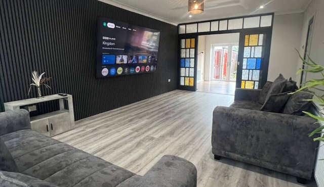 Spacious 4-bed home near Blackpool with huge TV and private garden