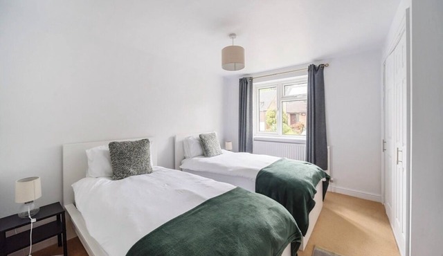 Spacious 4-bedroom townhome in charming Charlton Kings with driveway parking