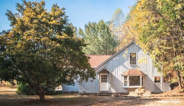 Spacious 4-bedroom farmhouse with 20 acres surrounded by a whitewater creek.