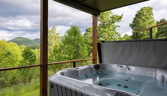 Spacious 4BR mountain retreat with long-range views, hot tub, game room, and fenced yard. Enjoy double decks, fire pit, and cozy interiors. Perfect for spring getaways, group stays, and relaxing mountain escapes.