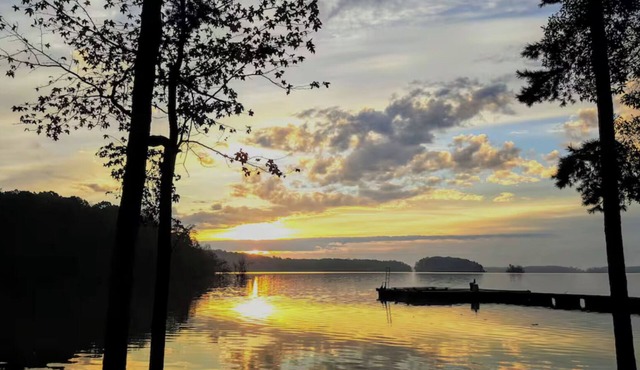 Spacious 4BR wooded lakefront house, with dock, multiple decks & ample parking.