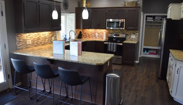 Spacious 5-bed 4-bath retreat. Backyard oasis with pool, hot tub, and fireplace.