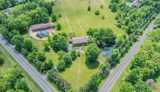 Spacious 5-bedroom lodge on 35 acres with pool house, pool, 2 ponds, waterfall!