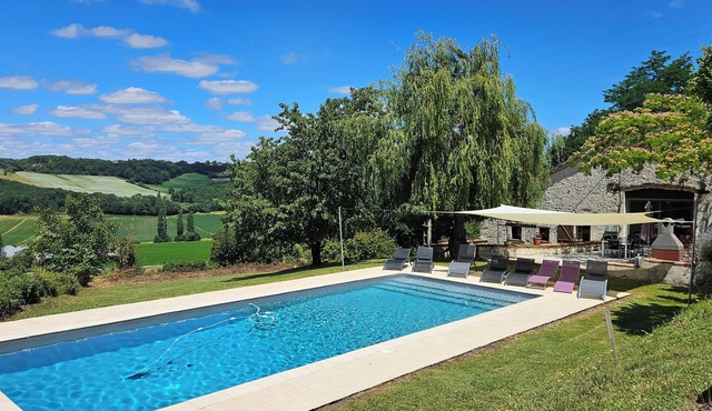 Spacious, beautifully converted barn with exposed wooden beams, swimming pool