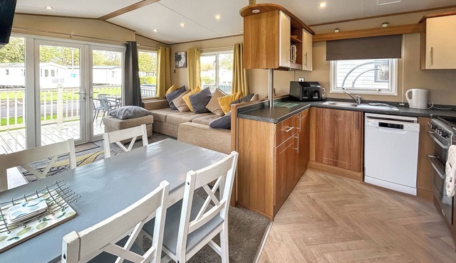 Spacious caravan sleeps six, with private decking and master ensuite.