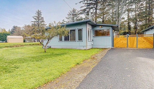 Spacious coastal property with separate living quarters, wood stove, & grill